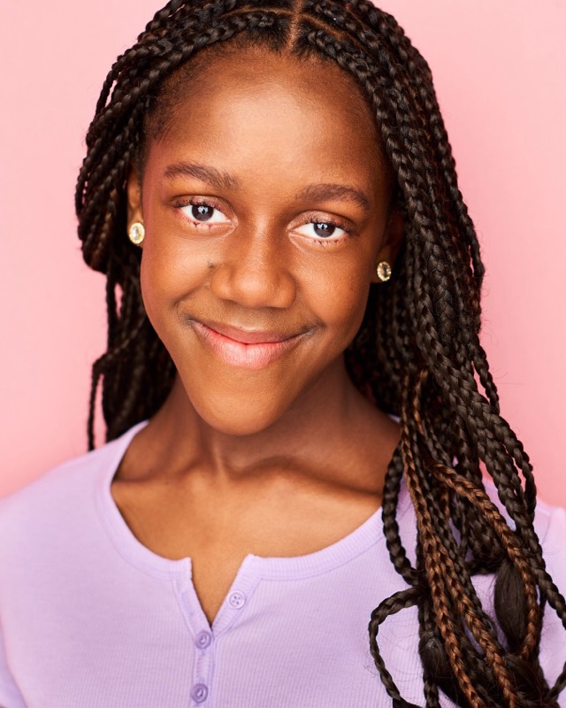 Abby Bernard in a lavender top, smiling softly
